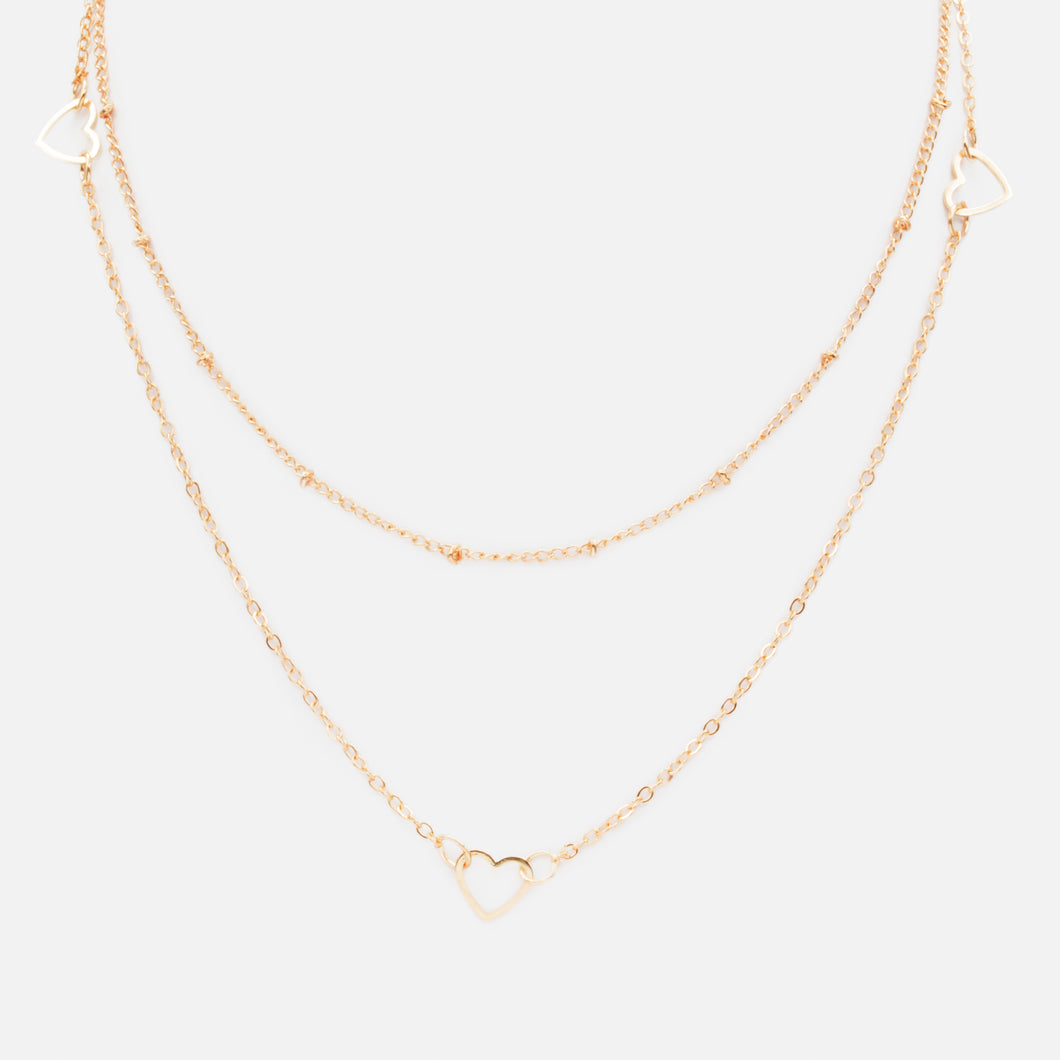 Collier doré double chaîne avec trio de coeurs