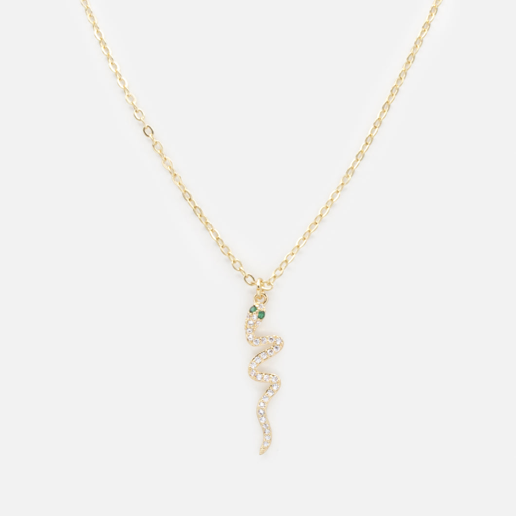 Gold snake charm necklace with cubic zirconia and emerald stones