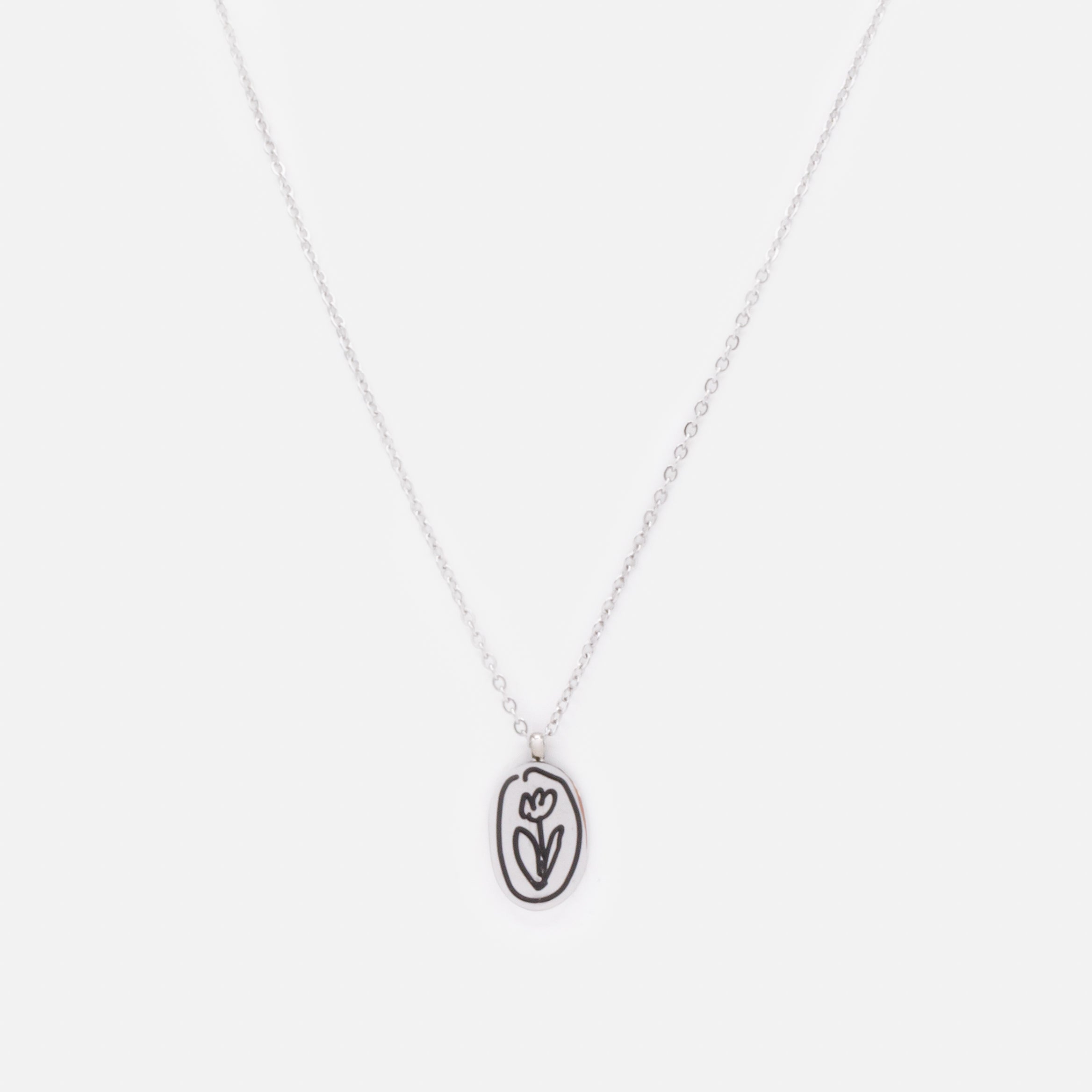 Silver necklace with black engraved flower charm