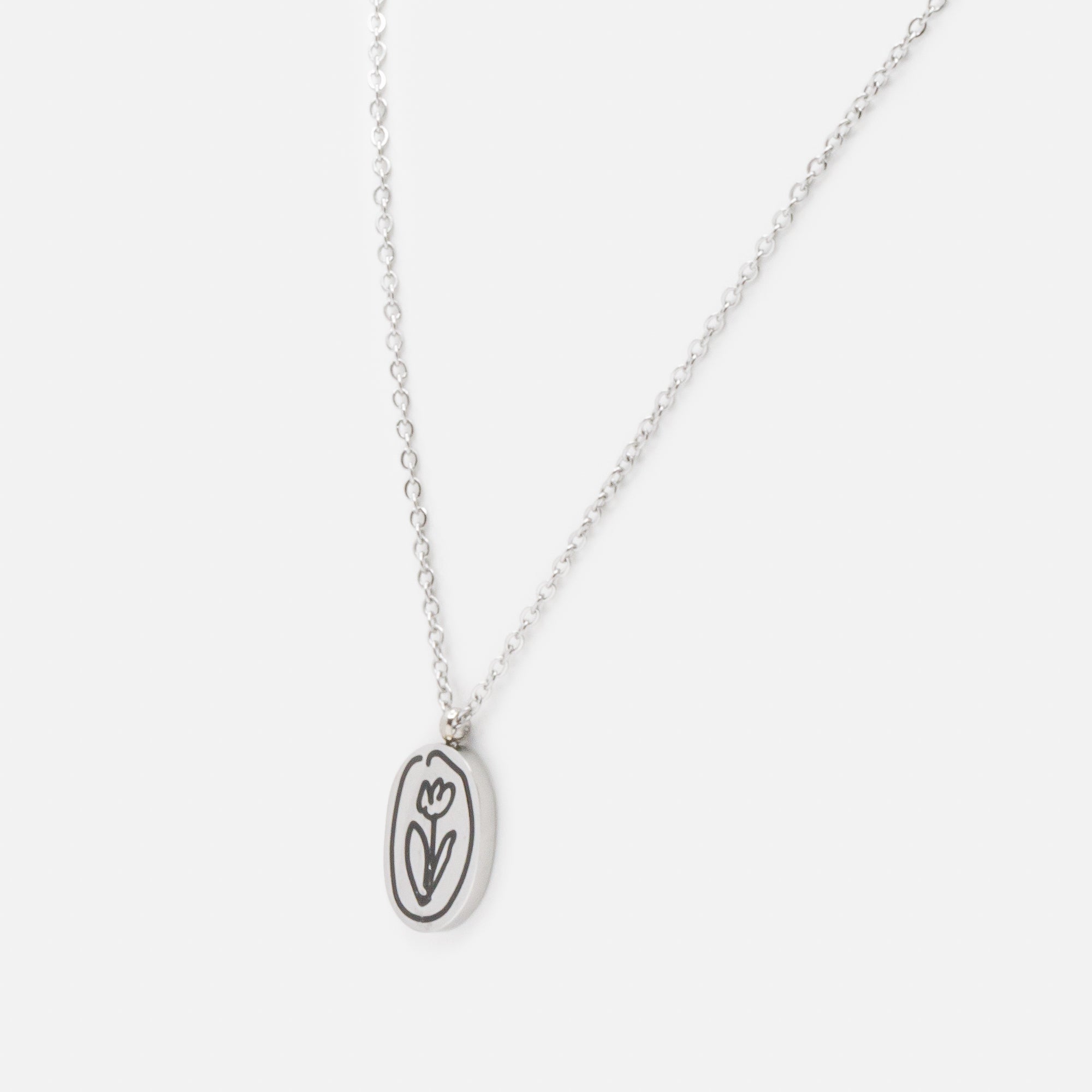 Silver necklace with black engraved flower charm