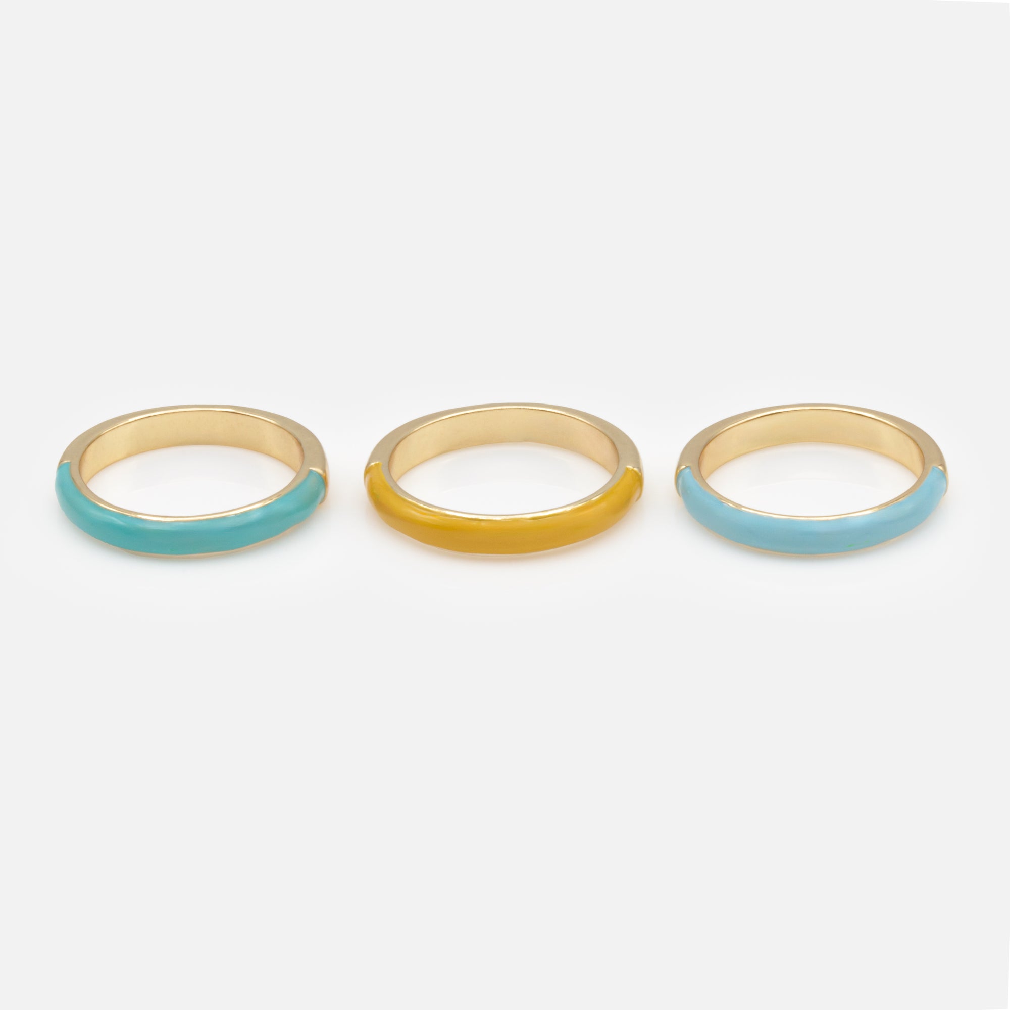 Trio of gold rings with colored band