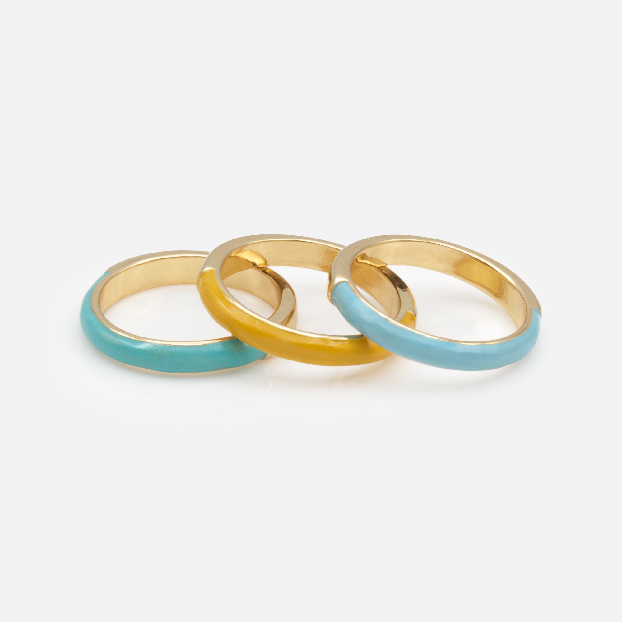 Trio of gold rings with colored band