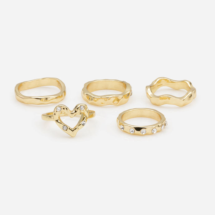 Set of five hammered gold rings in various sizes with cubic zirconia stones