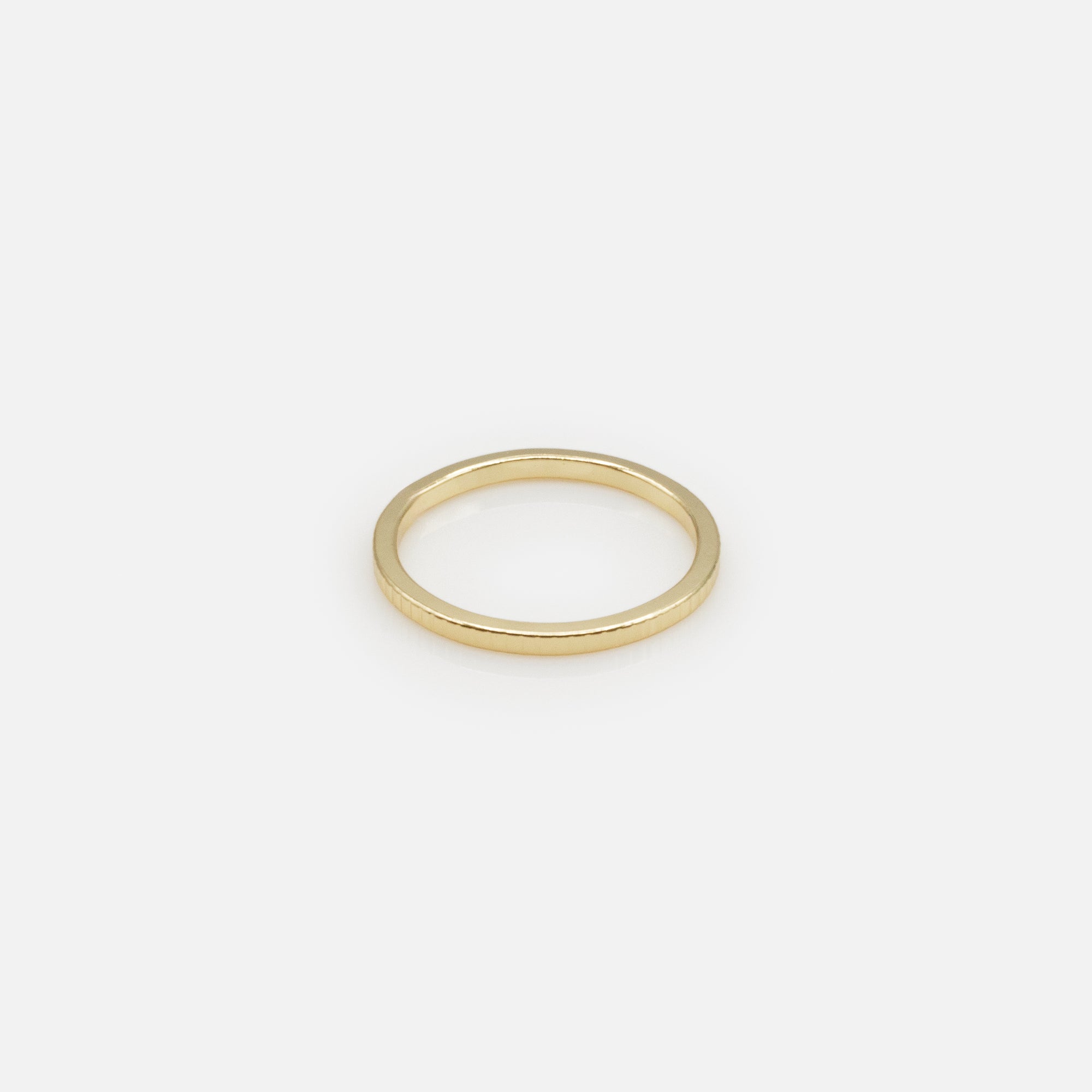 Set of four gold rings in various sizes with texture and cubic zirconia