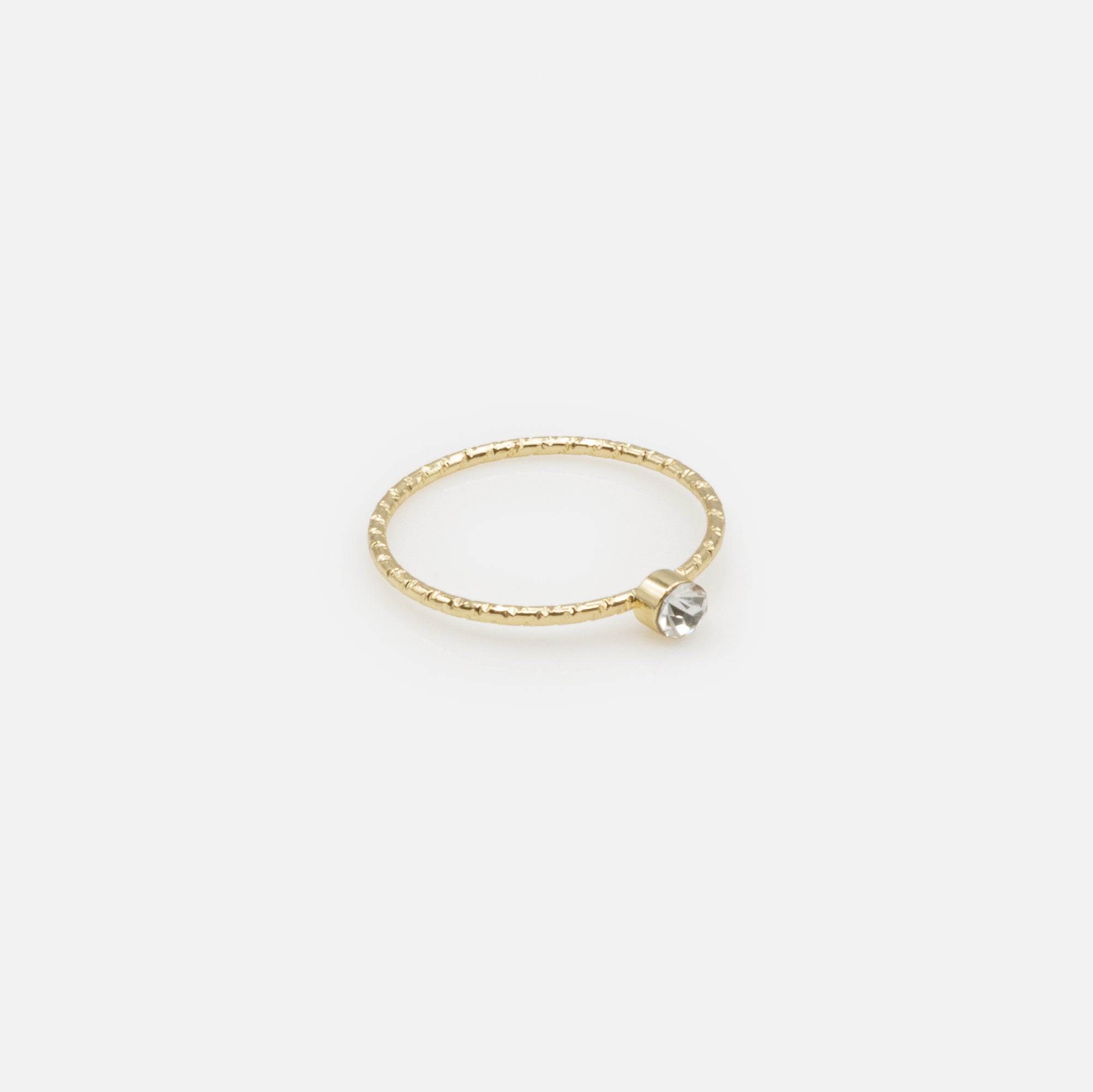 Set of four gold rings in various sizes with texture and cubic zirconia
