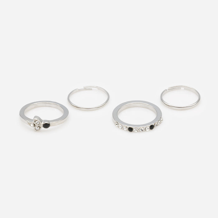 Set of four silver rings in various sizes with black and translucent zircons
