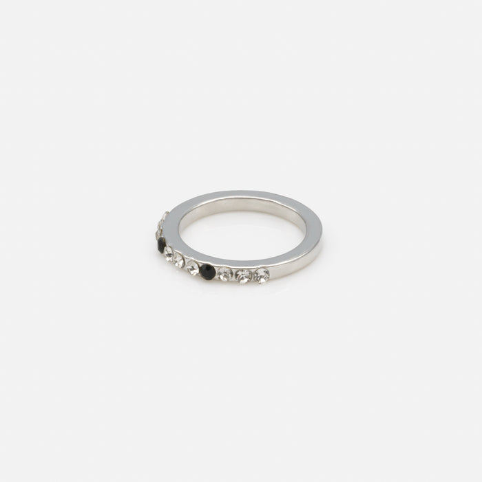 Set of four silver rings in various sizes with black and translucent zircons
