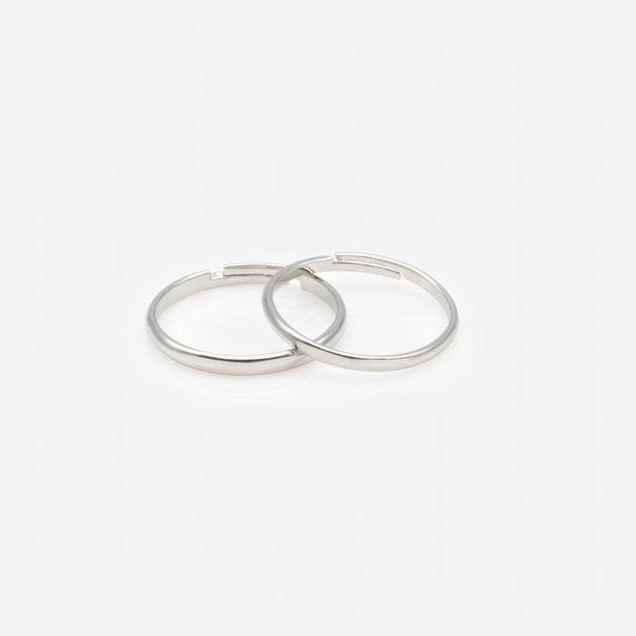 Set of four silver rings in various sizes with black and translucent zircons