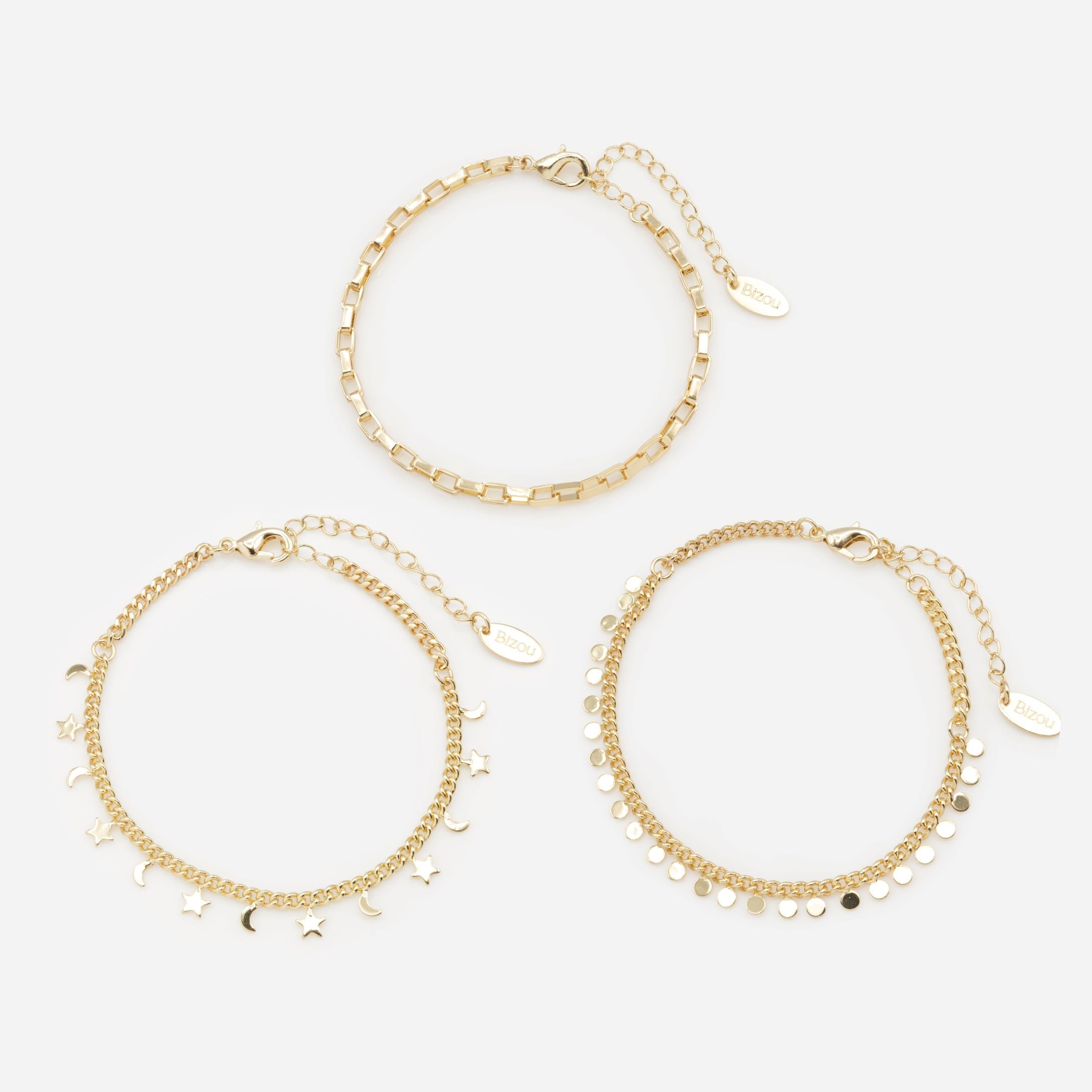 Trio of gold bracelets with moon, star and circle charms