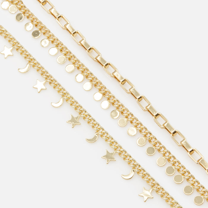 Trio of gold bracelets with moon, star and circle charms