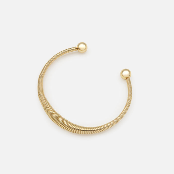 Rigid gold spring effect bracelet