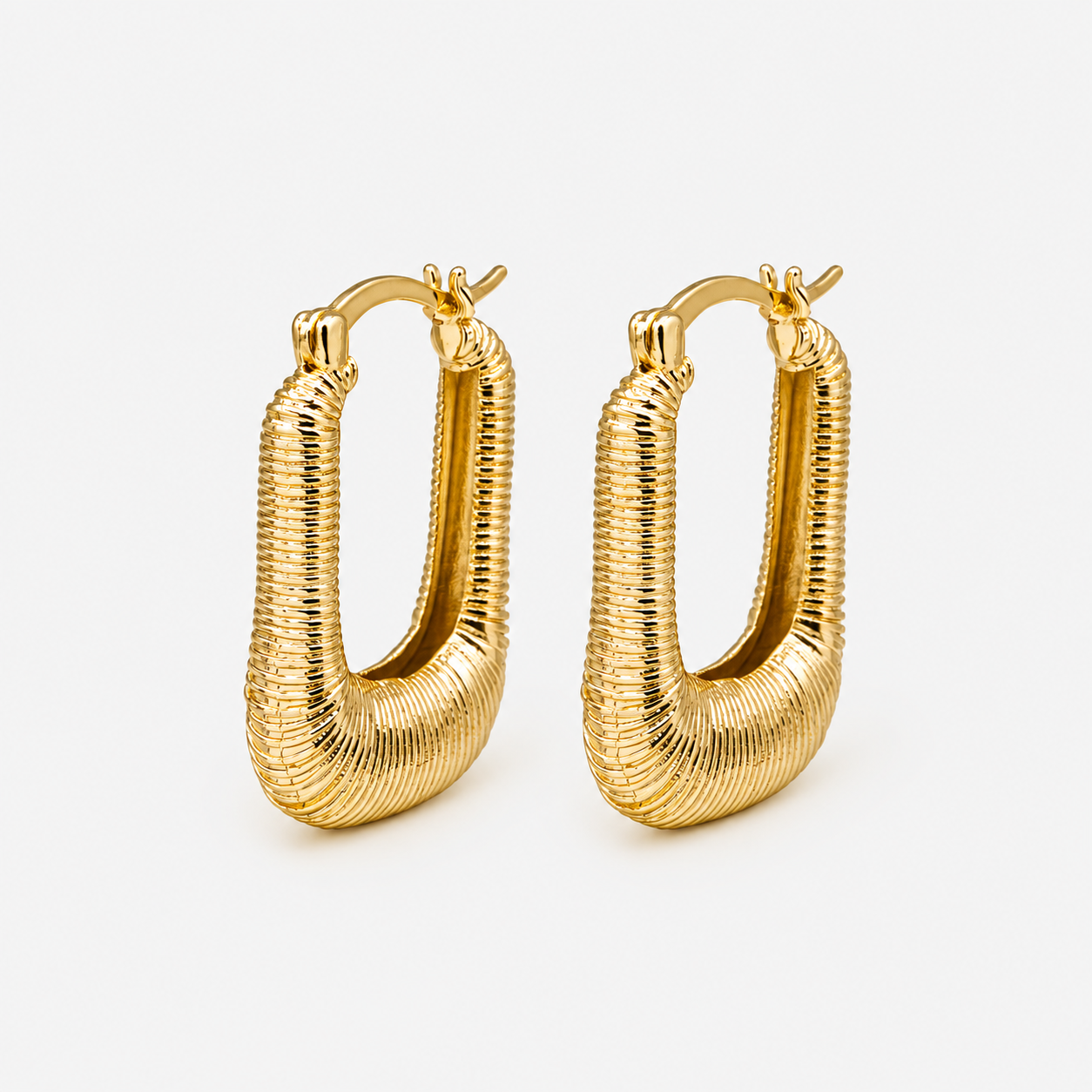 Oval grooved gold earrings