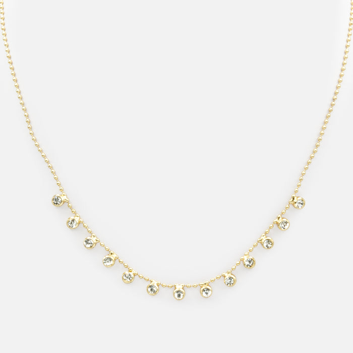 Collier de fines billes dorées avec breloques de zircons cubiques
