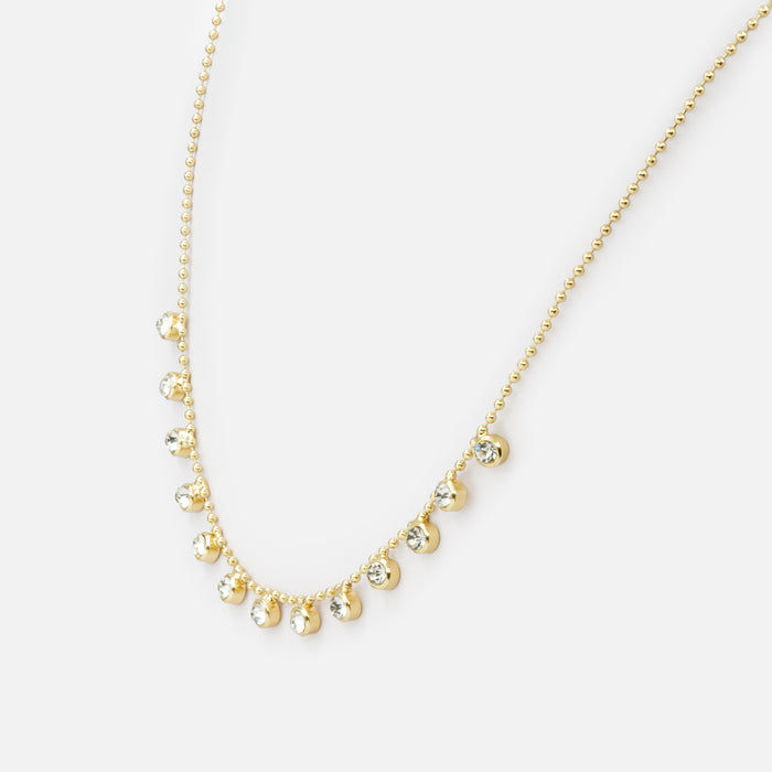 Collier de fines billes dorées avec breloques de zircons cubiques