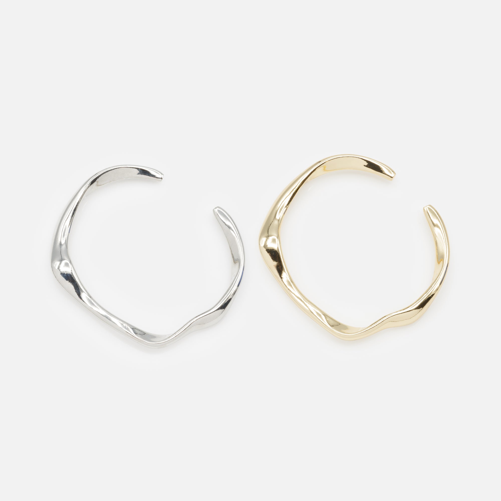 Duo of rigid gold and silver wave effect bracelets