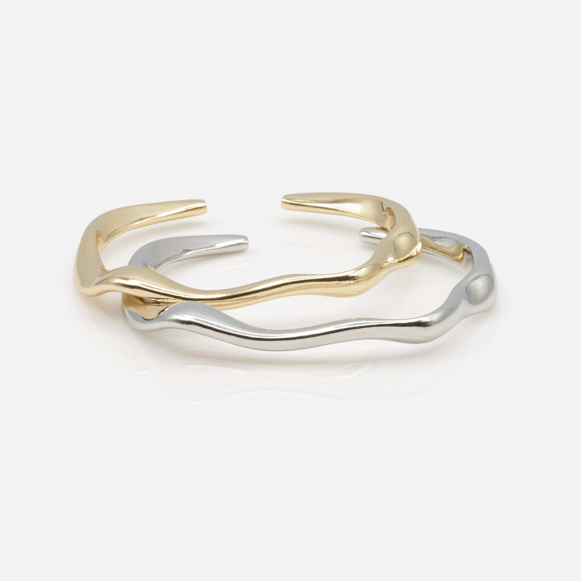 Duo of rigid gold and silver wave effect bracelets