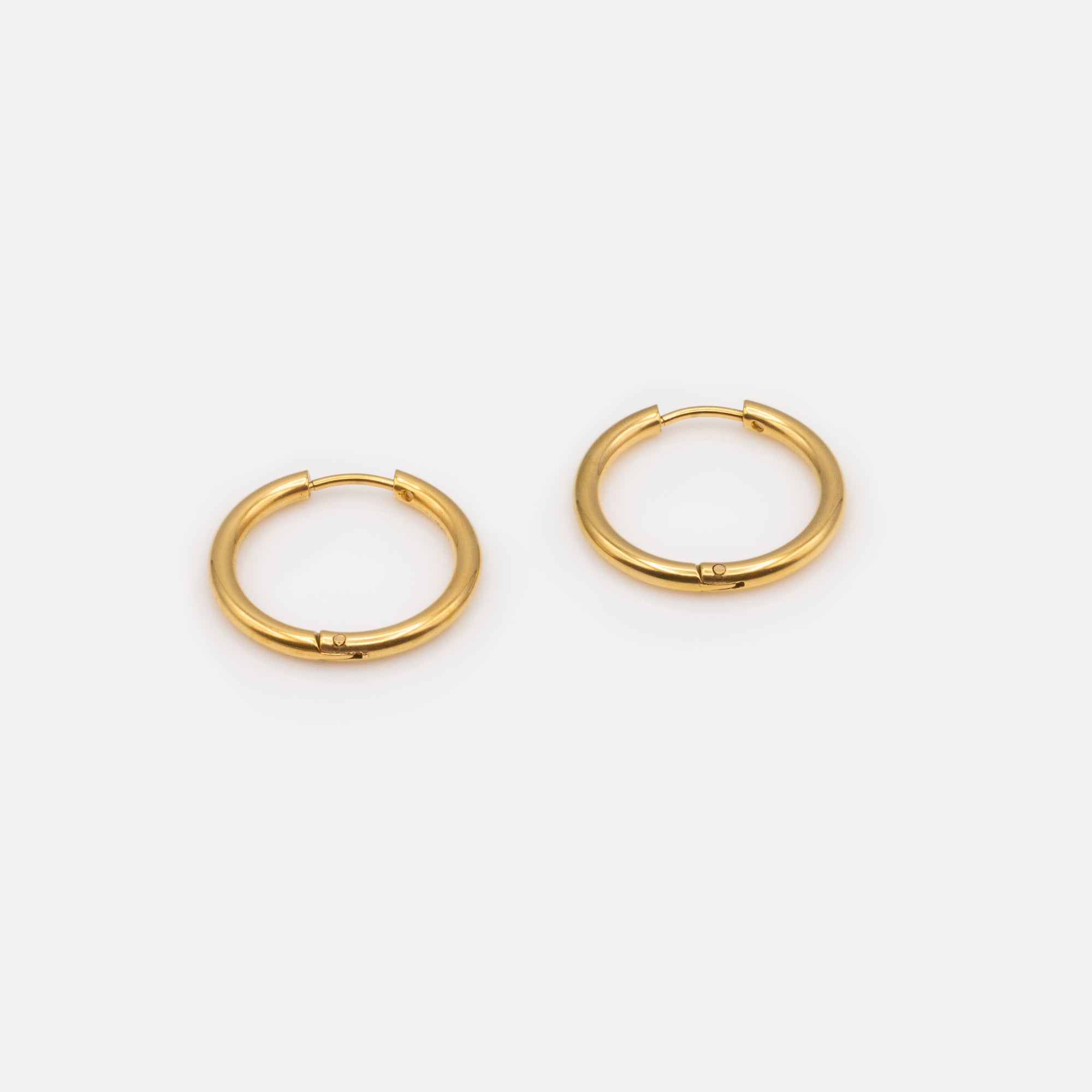 Trio of different golden hoop earrings in stainless steel