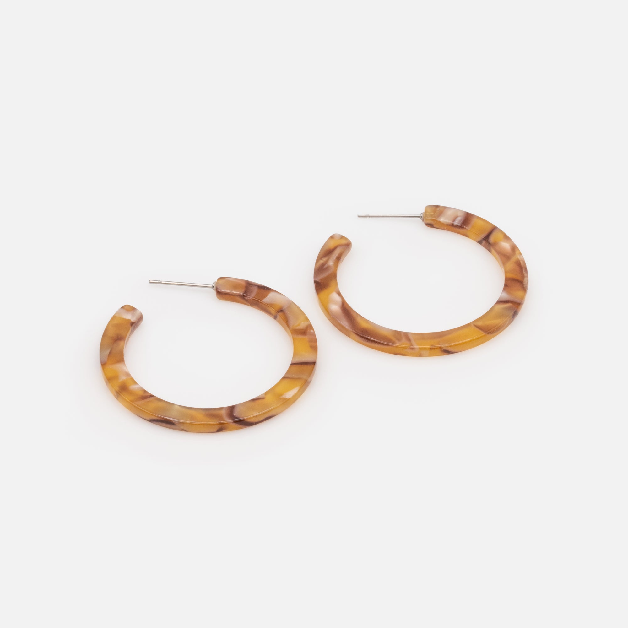 Trio of different golden hoop earrings in stainless steel