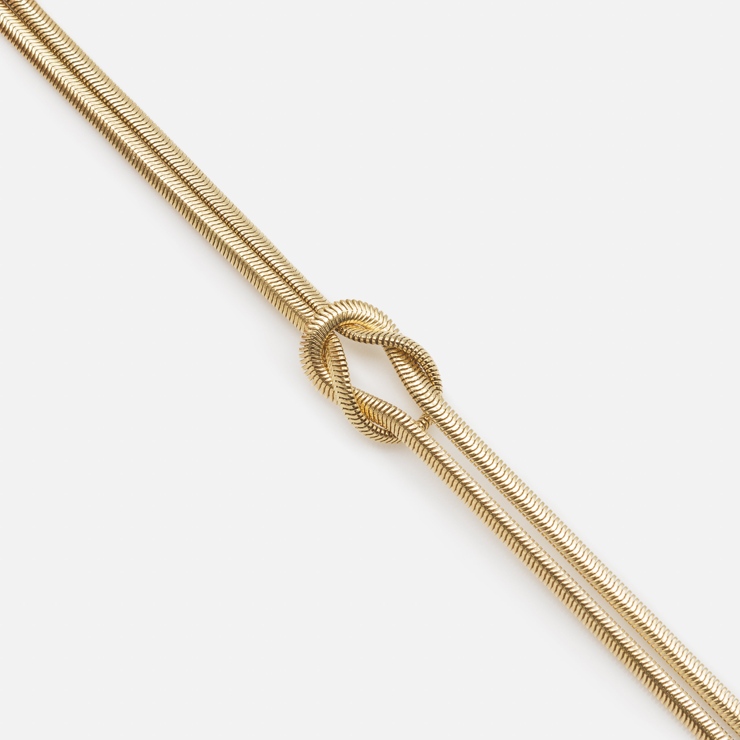 Gold knot bracelet with round serpentine links in stainless steel