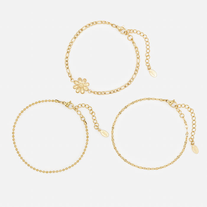 Ensemble de trois bracelets dorés avec fleur en acier inoxydable