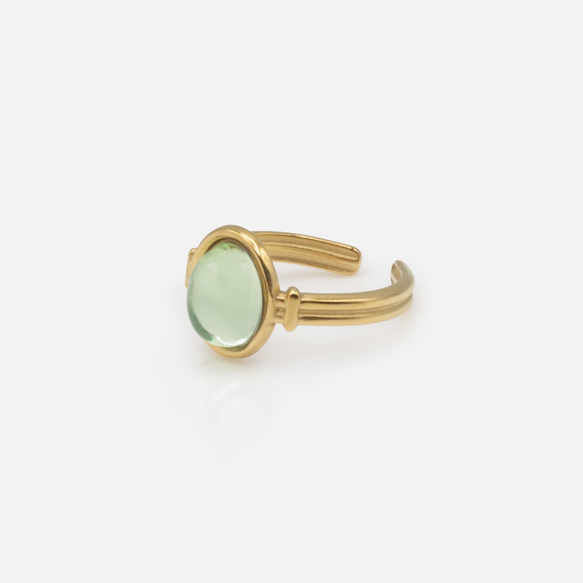 Golden ring with translucent oval green stone