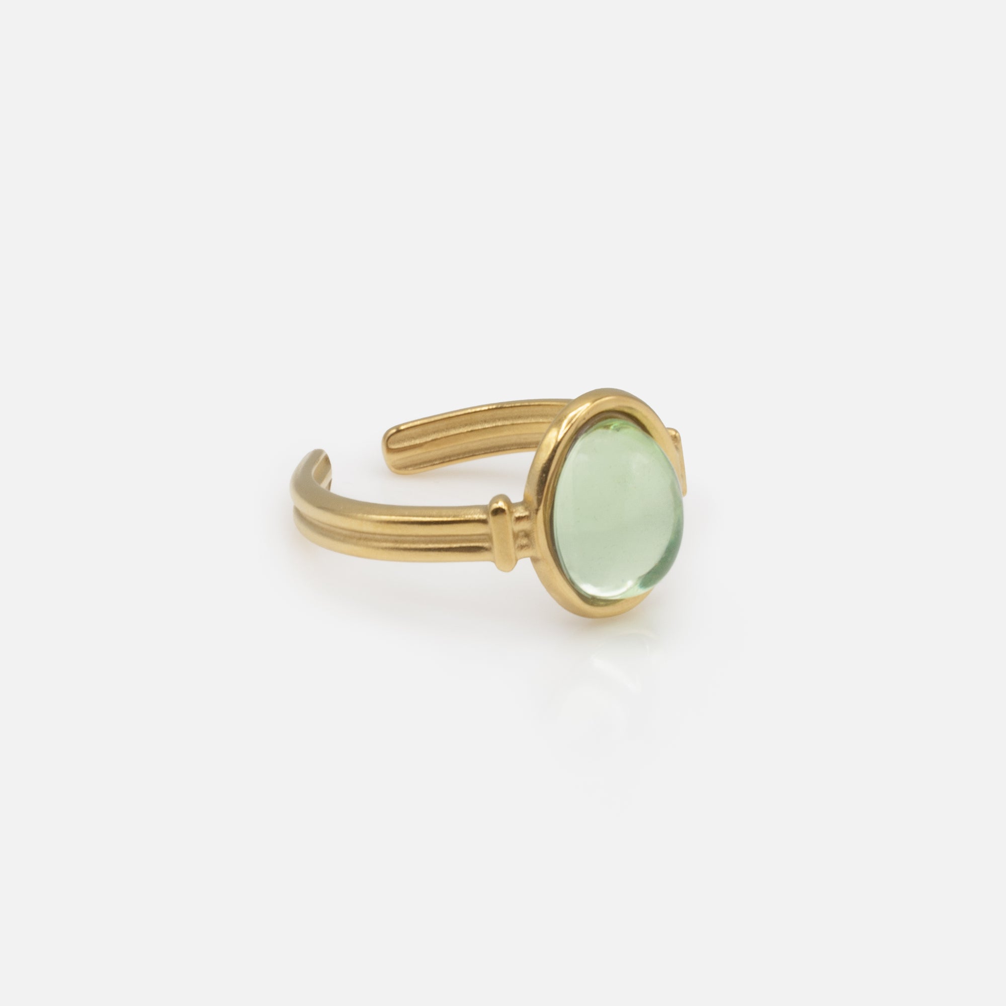 Golden ring with translucent oval green stone