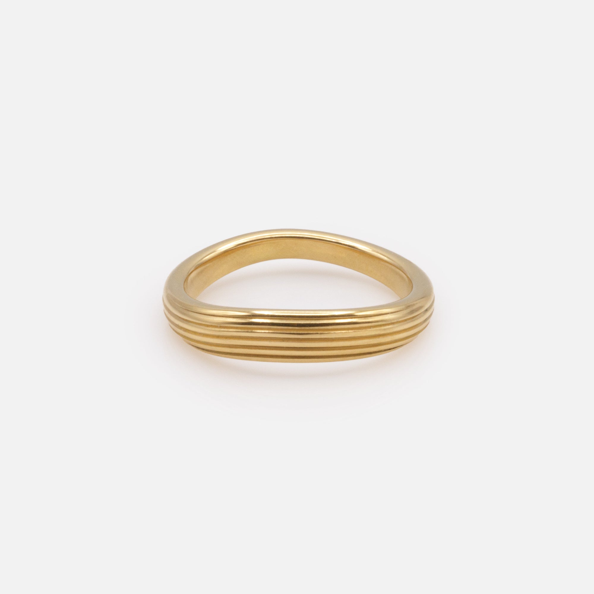 Curved grooved gold ring in stainless steel
