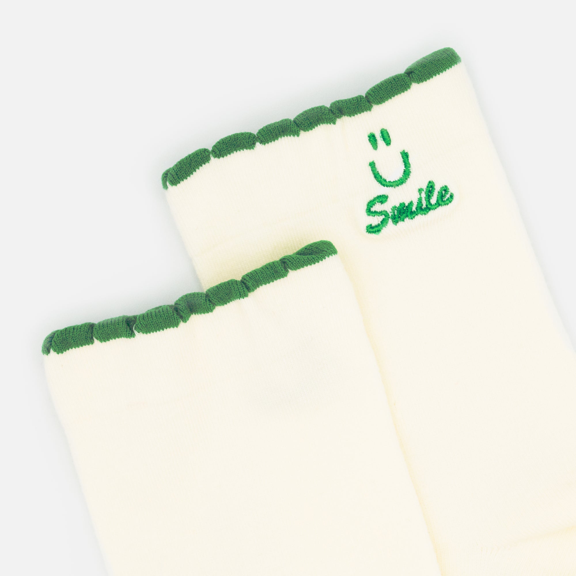 White stockings with Smile embroidery and green border