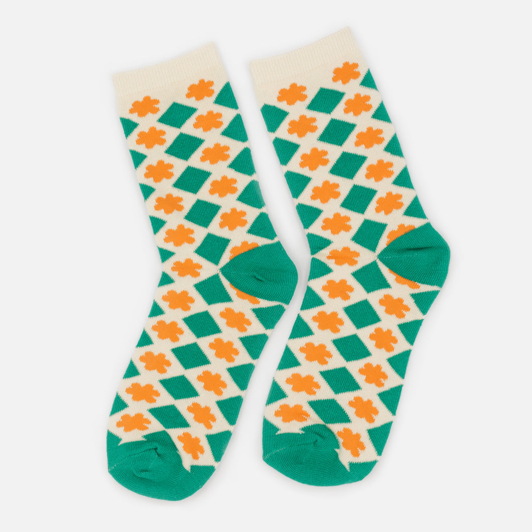 Cream stockings with green diamond patterns and orange flowers