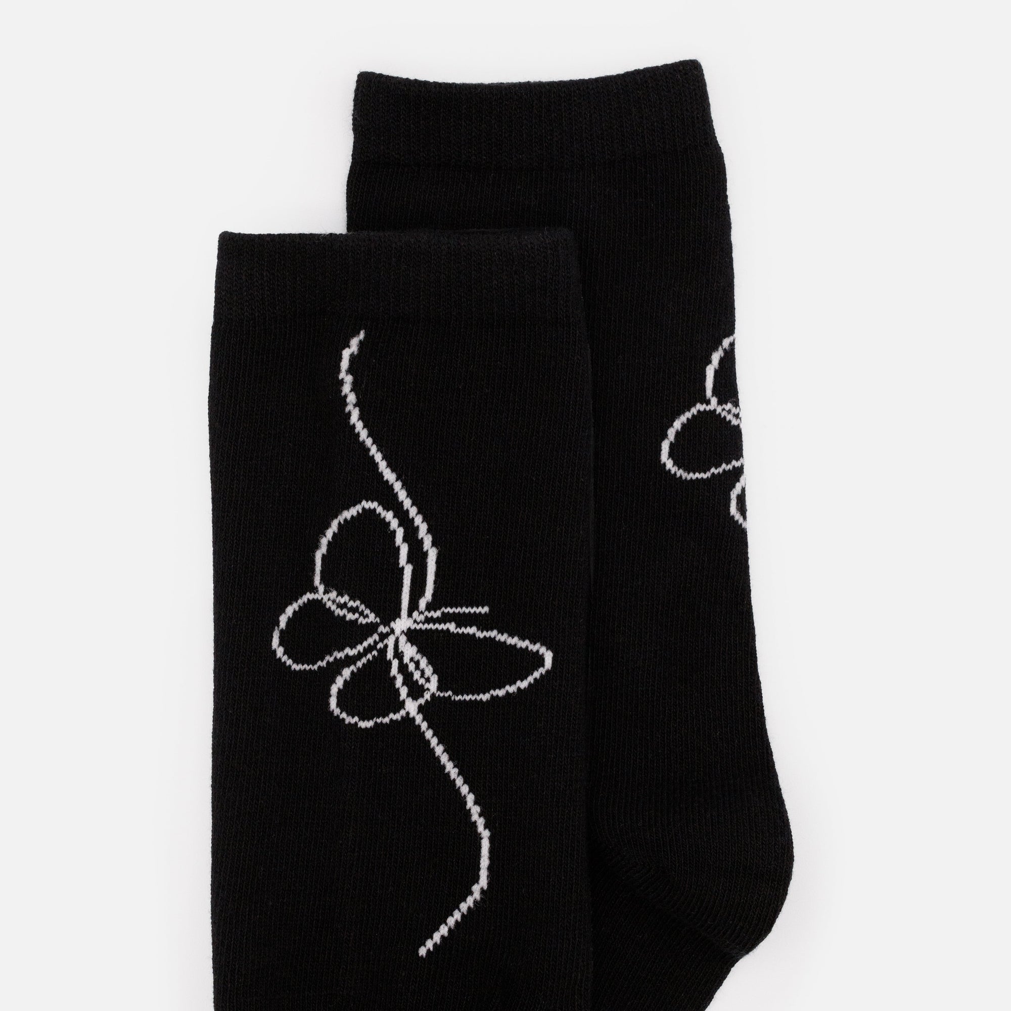 Bas noirs avec imprimé papillon blanc