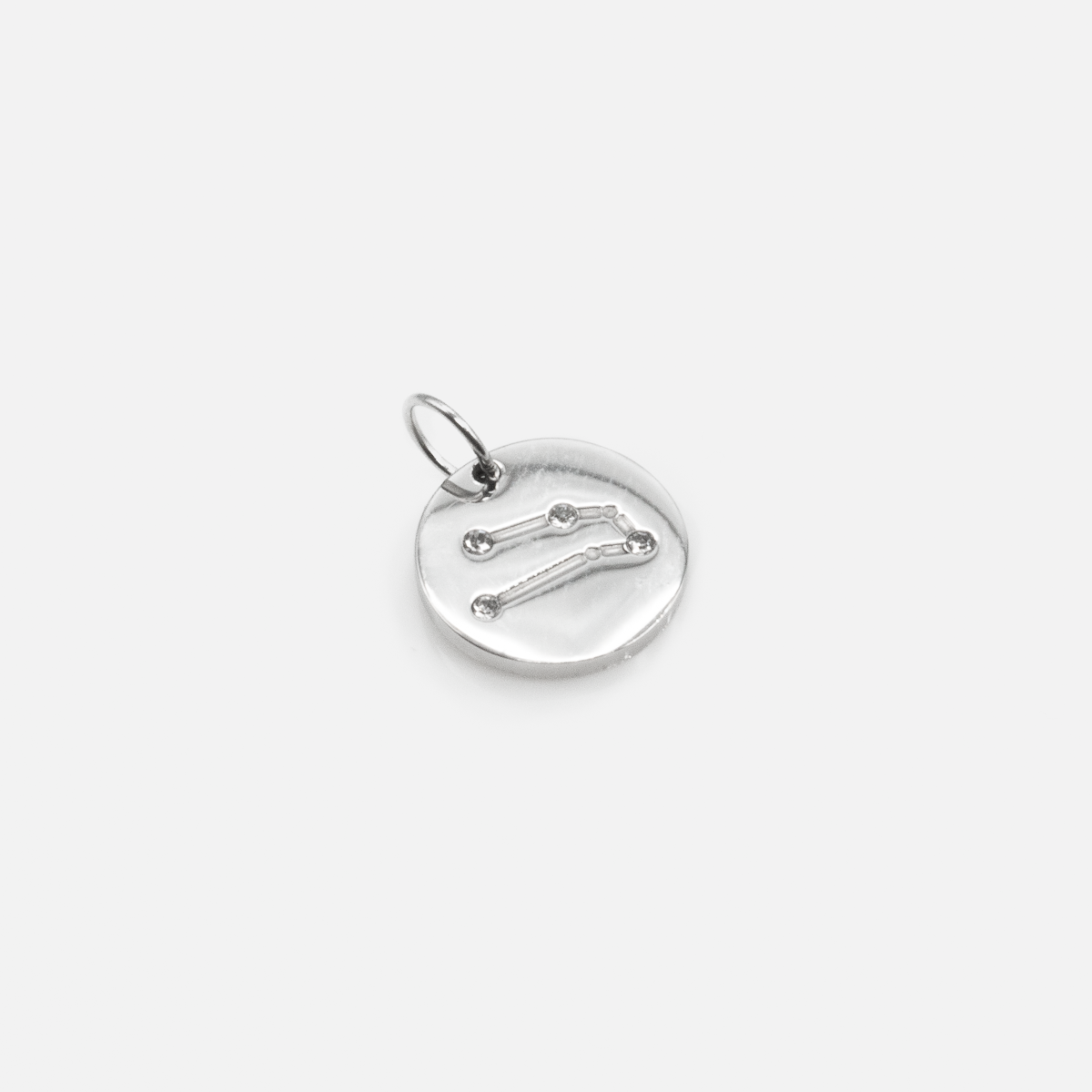 Small silvered charm engraved with the zodiac constellation "taurus"