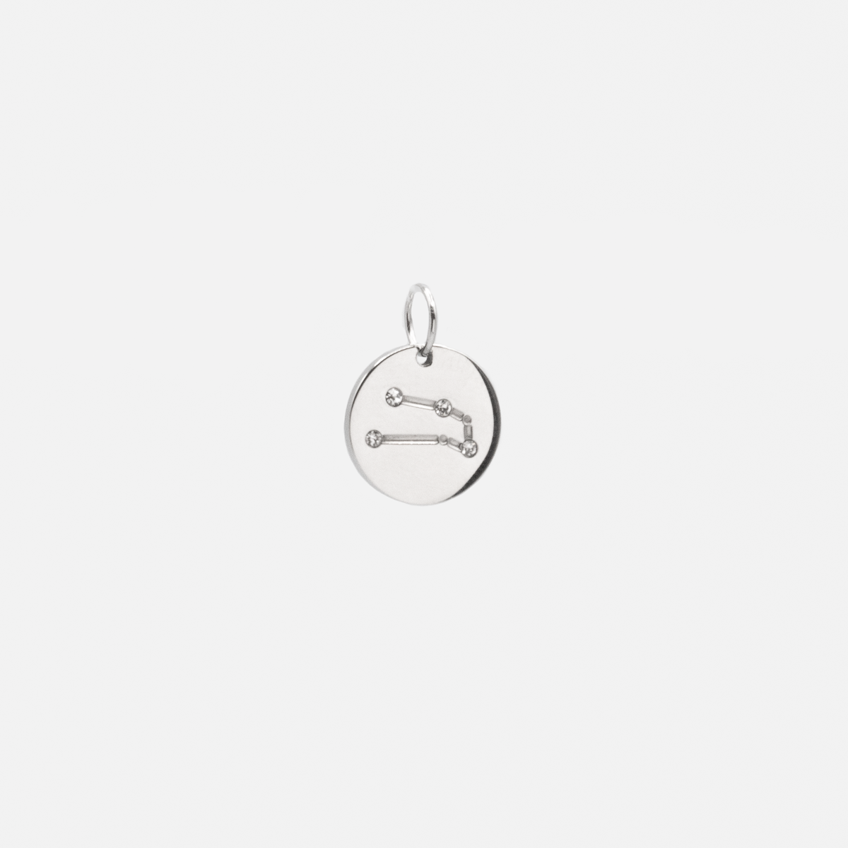 Small silvered charm engraved with the zodiac constellation "taurus"