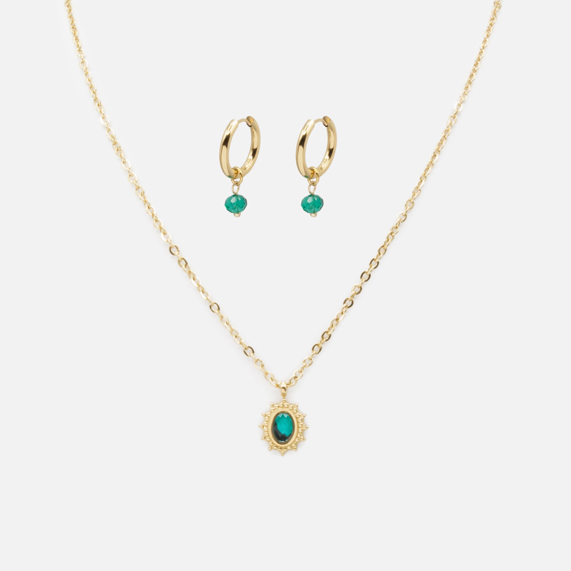 Gold ring necklace and earrings set with green stones in stainless