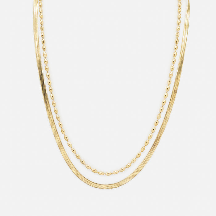 Collier doré double chaîne à mailles serpentines plates et billes allongées en acier inoxydable