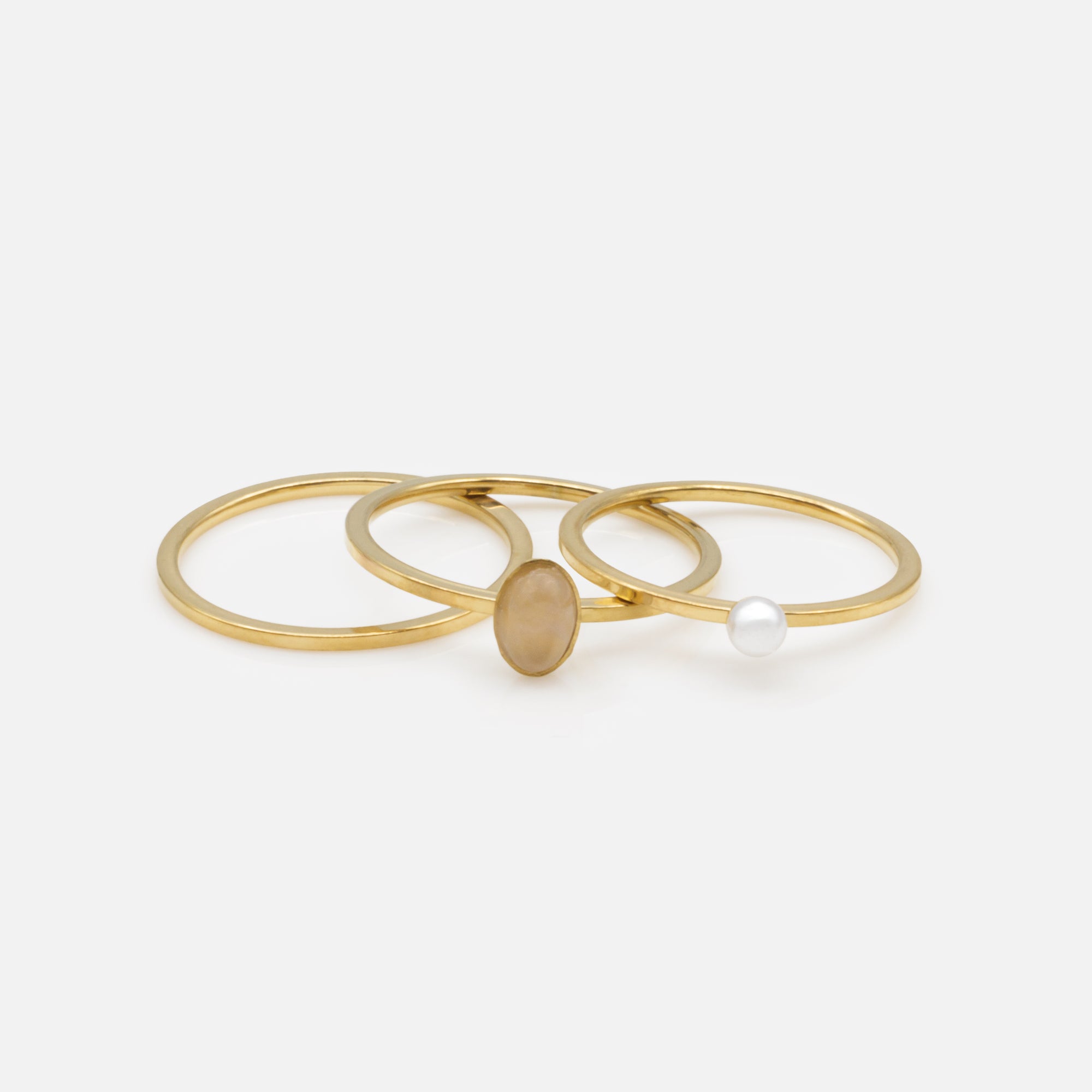 Trio of gold rings with translucent stone and stainless steel pearl