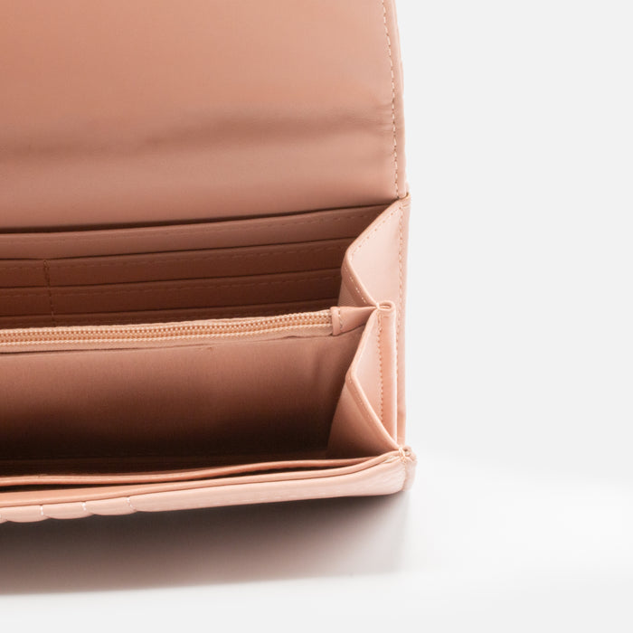Old pink quilted wallet with linear patterns