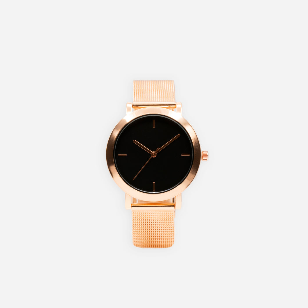 Rose gold watch with round black dial