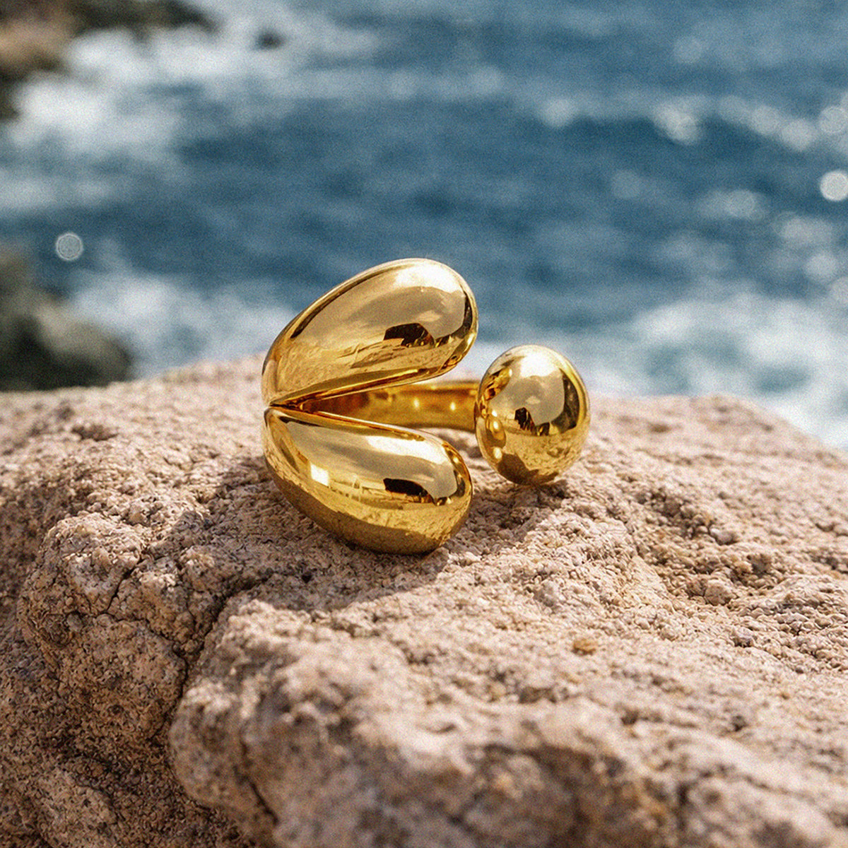 Bizou SF253R029GL – Gold chunky sculptural statement ring on coastal rock by the sea, Mediterranean lifestyle, Bizou jewelry