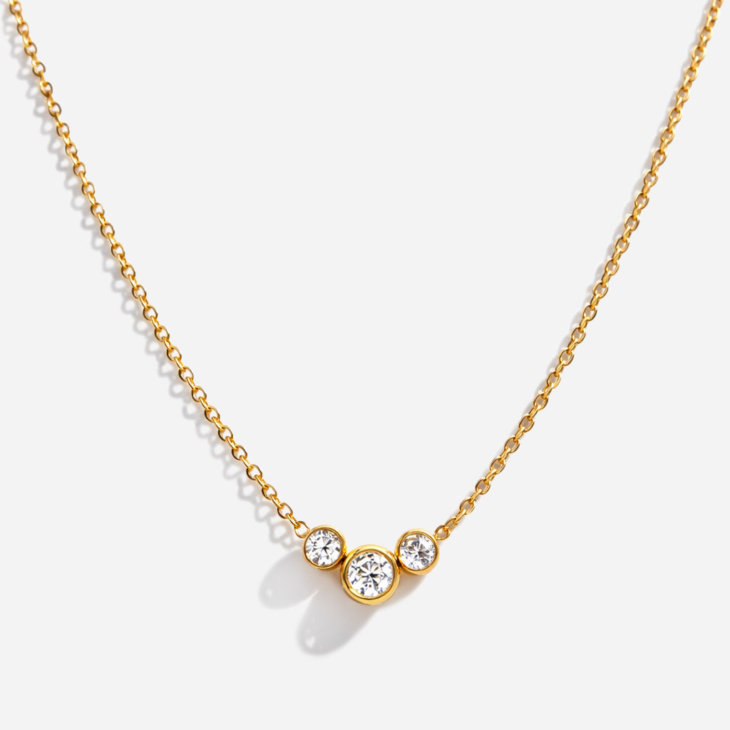 Bizou SS253N014GL – Gold triple bezel cubic zirconia necklace in stainless steel, three graduating CZ stones on delicate chain, front view
