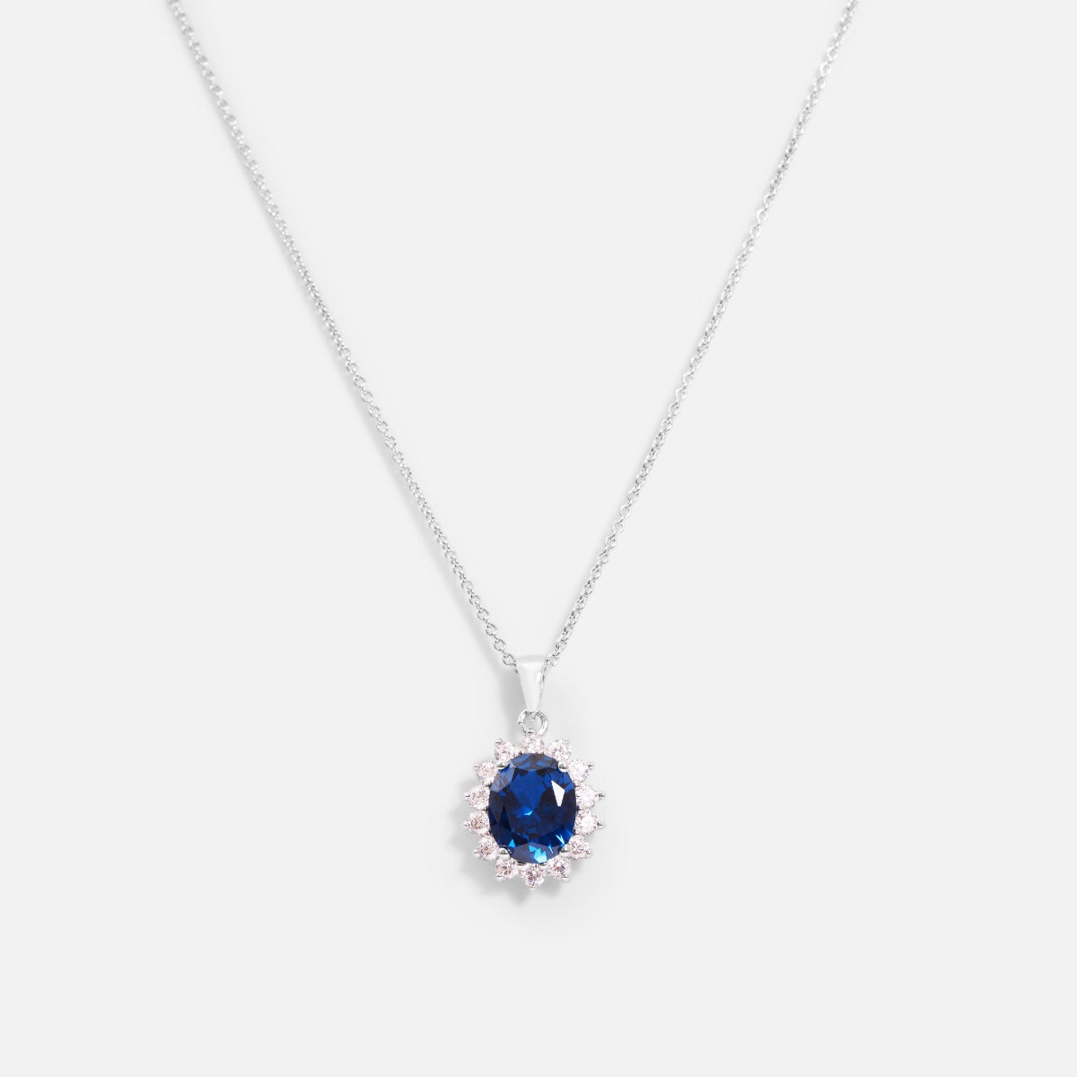 Thin sterling silver chain necklace with blue and silver cubic zirconia pendant