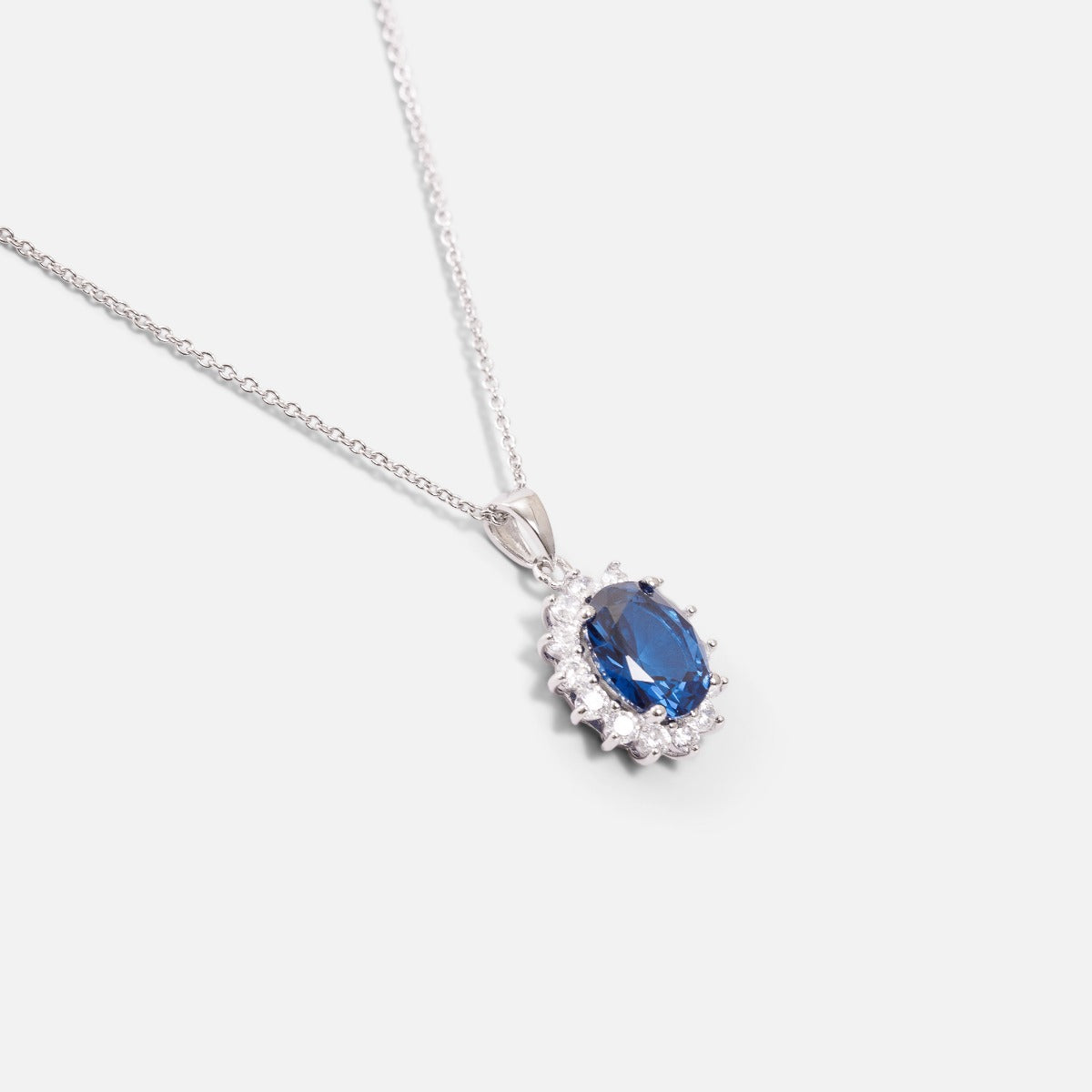 Thin sterling silver chain necklace with blue and silver cubic zirconia pendant