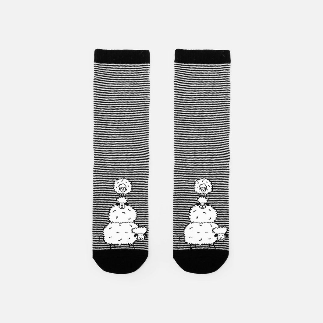 Black and white striped socks with three playful sheeps 