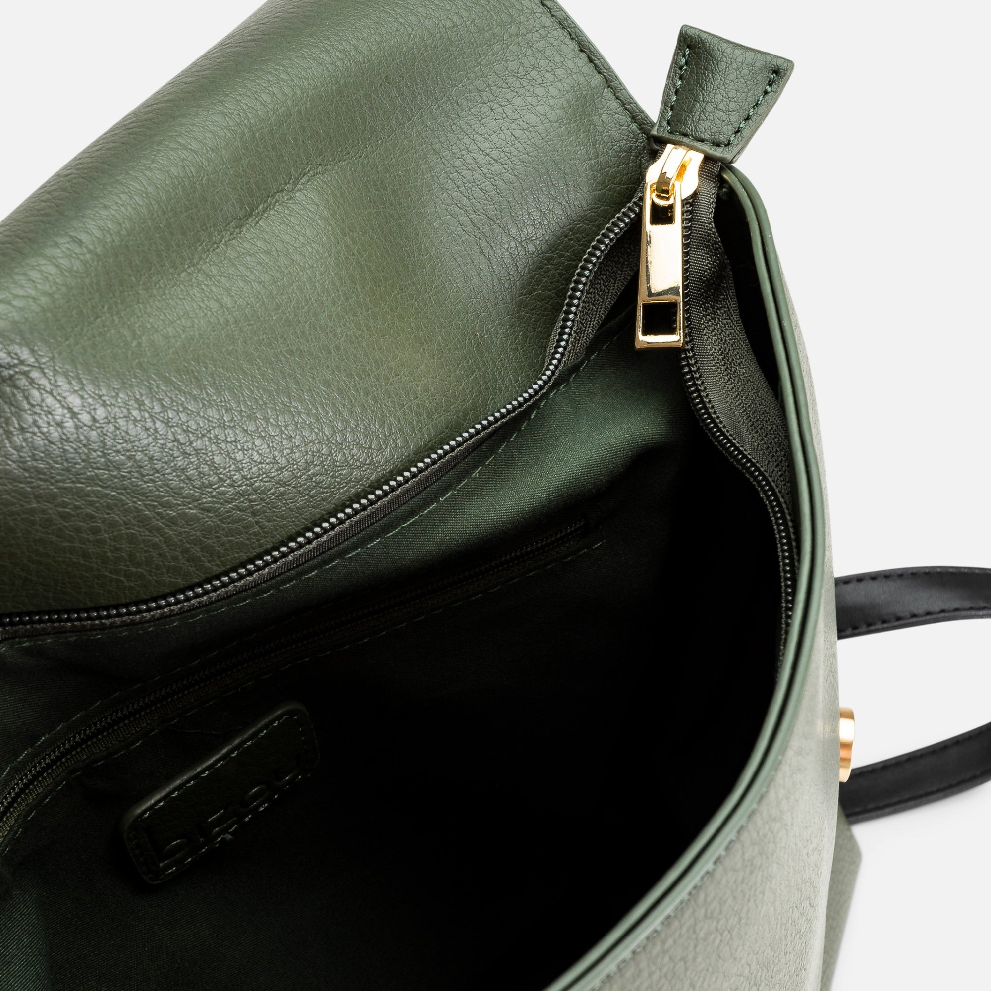 Dark green backpack with large flap and black handle