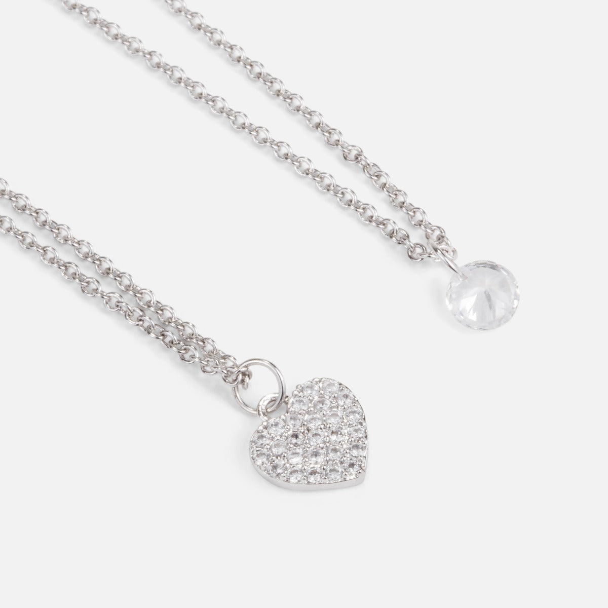 Duo of cubic zirconia pendants with heart and stone