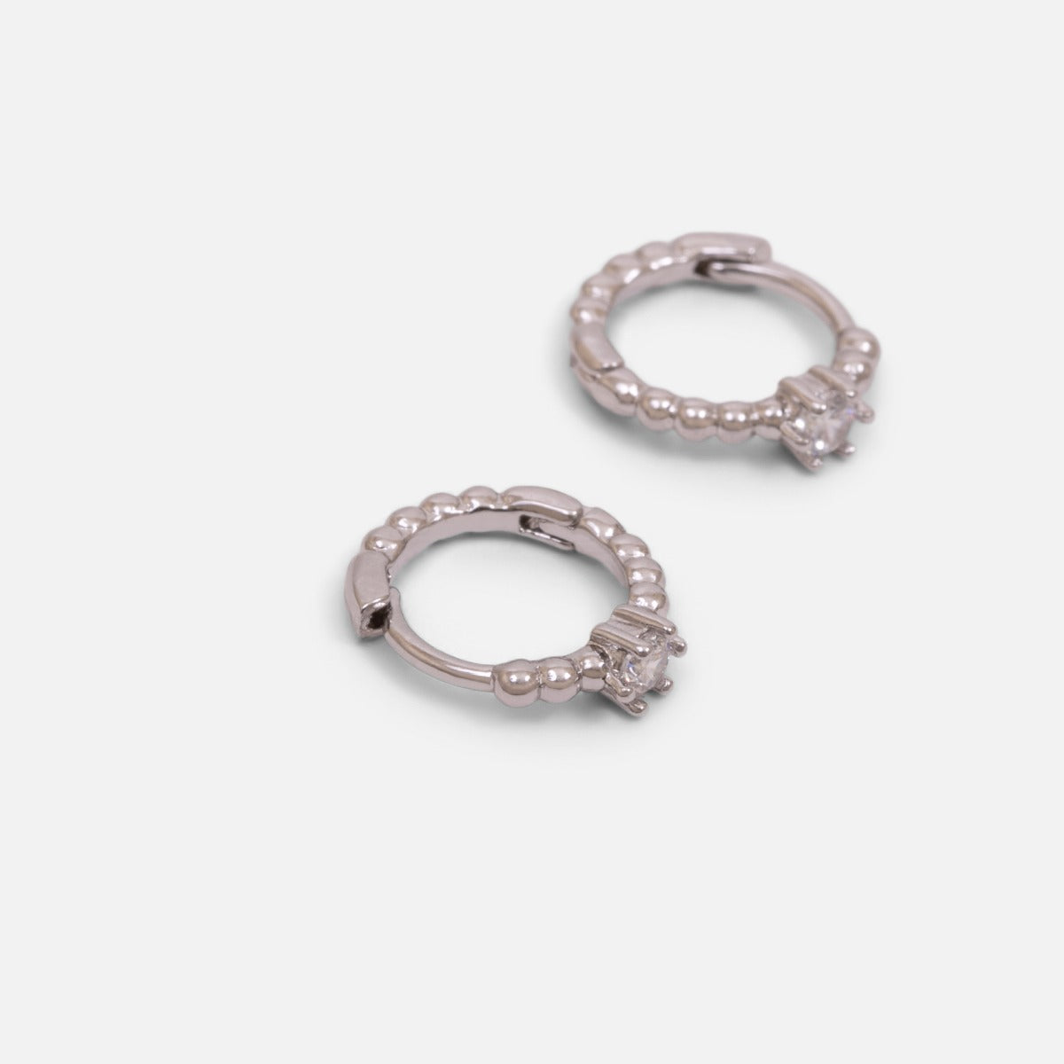 Set of three silvered fixed and hoop earrings