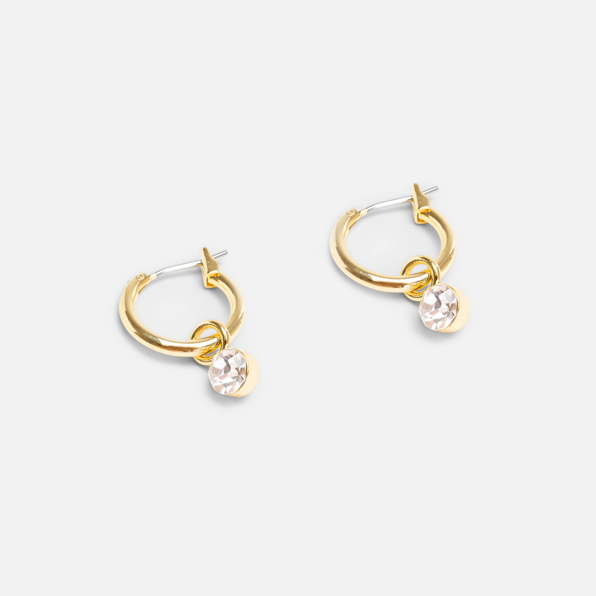 Golden hoop earrings with small silver charm 