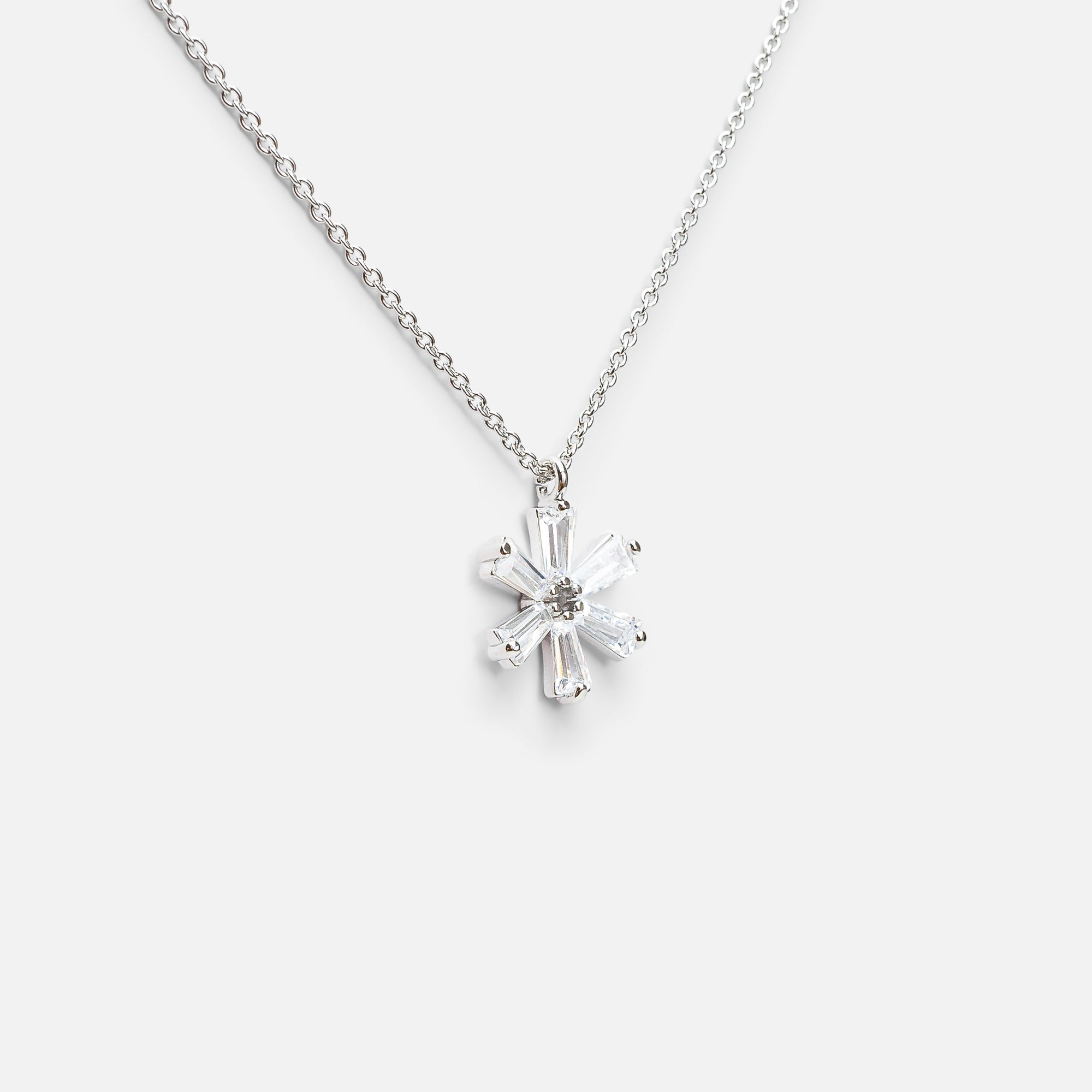 Silver pendant with small flower