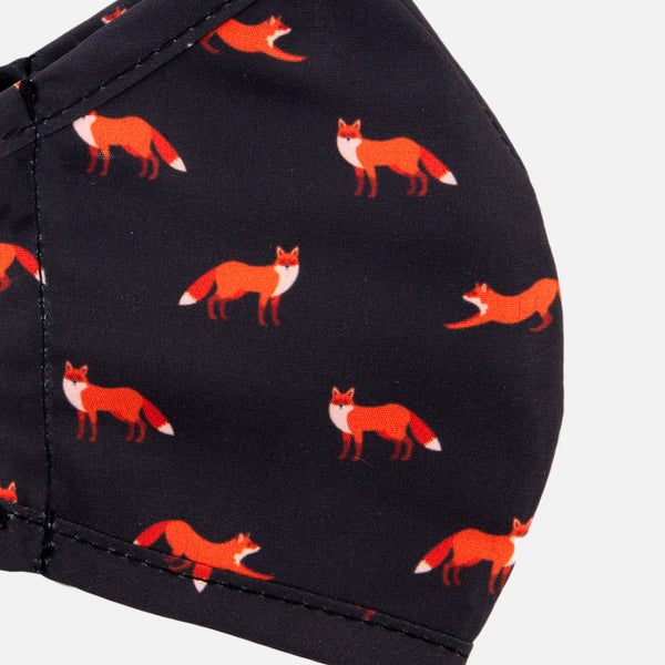 Load image into Gallery viewer, Reusable charcoal face mask for kids with small orange foxes
