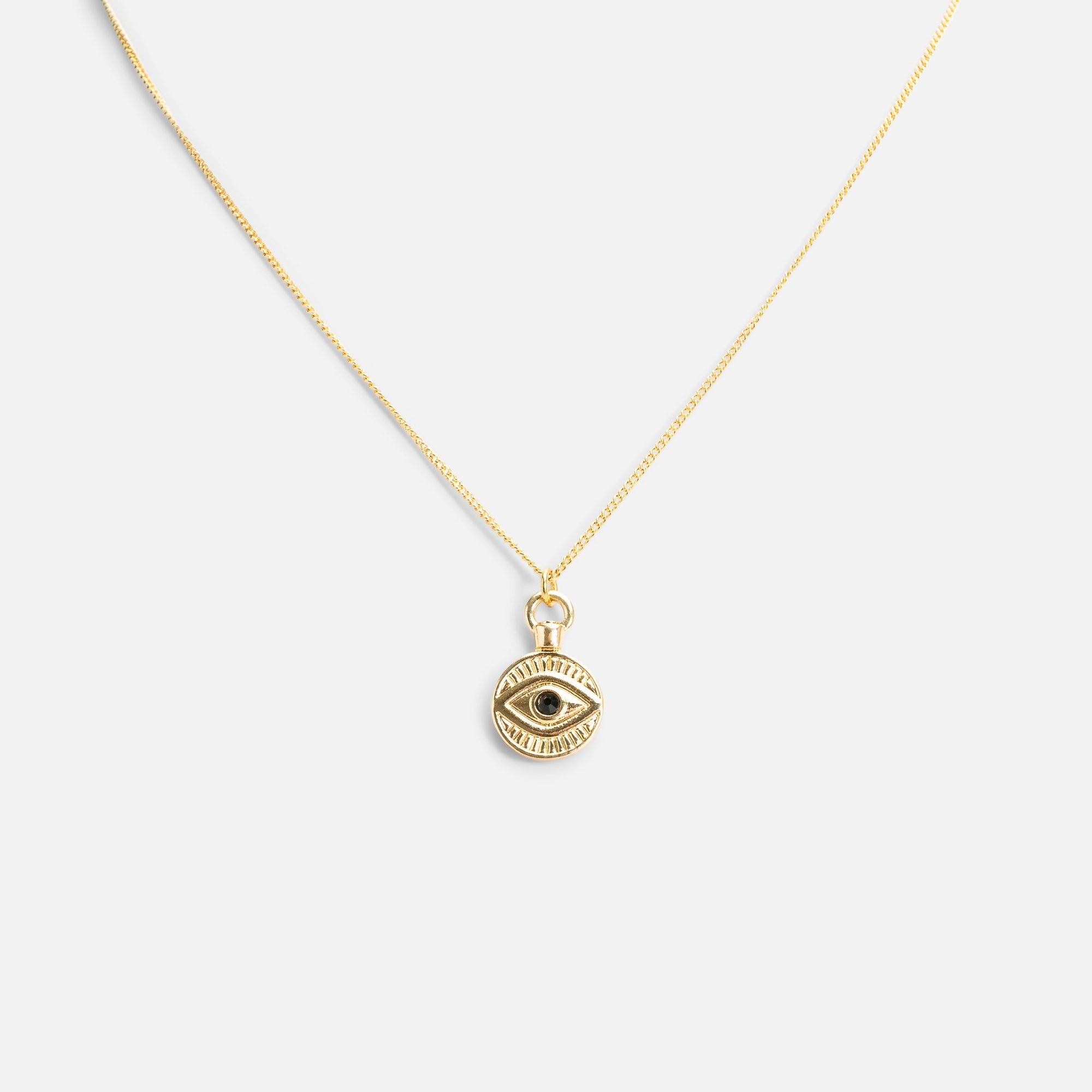 Reversible golden pendant with eye and star medallions