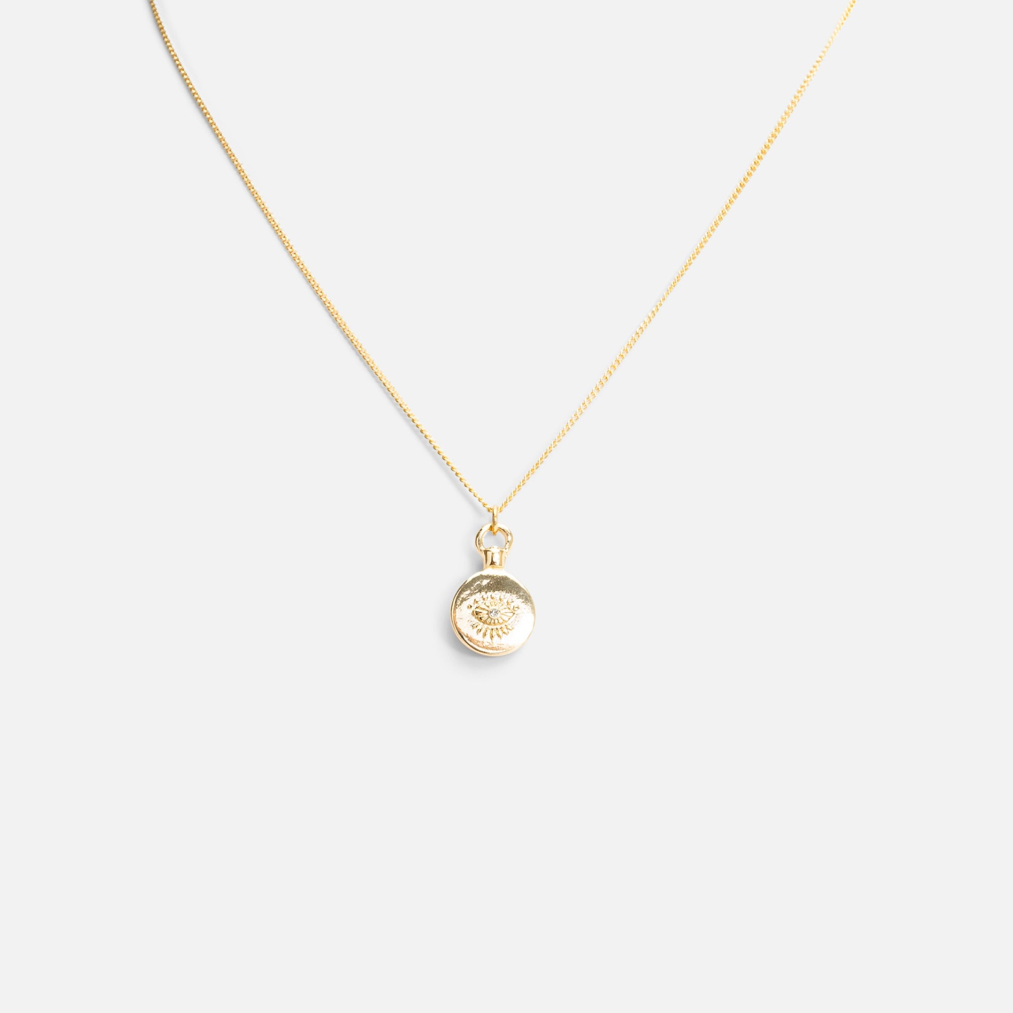 Reversible golden pendant with eye and star medallions